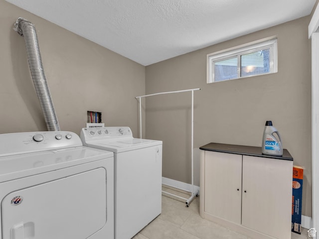 787 E Casa Blanco Cir, Midvale, UT 84047 - laundry area featuring washer and clothes dryer, light tile patterned floors, and a textured ceiling