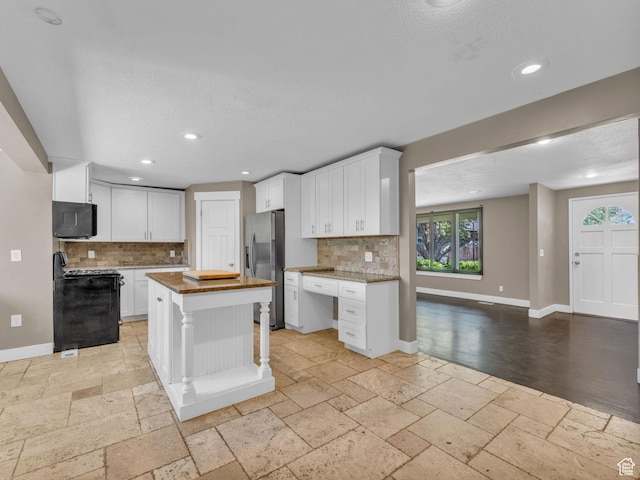 787 E Casa Blanco Cir, Midvale, UT 84047 - kitchen featuring stainless steel refrigerator with ice dispenser, stove, stone tile floors, tasteful backsplash, and recessed lighting