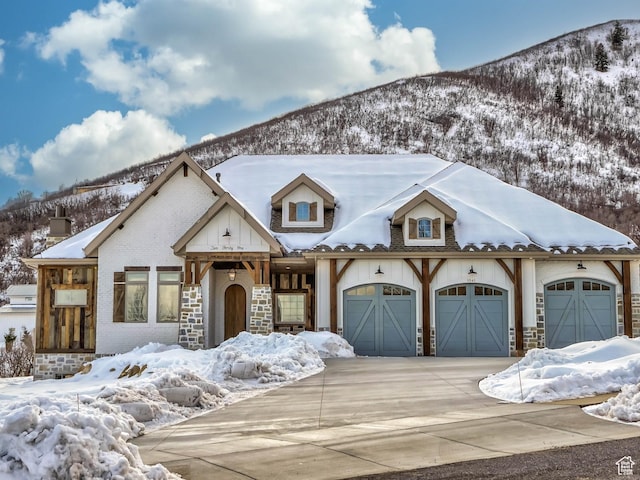 1023 W Lime Canyon Rd, Midway, UT 84049 - view of front of house with driveway, a mountain view, an attached garage, and stone siding