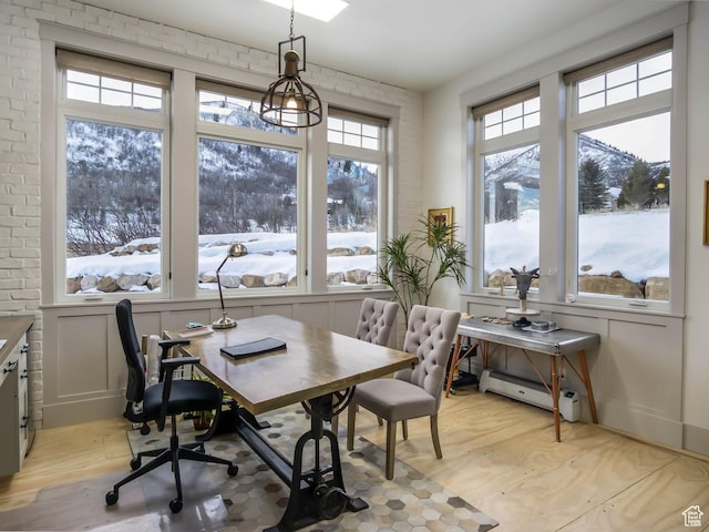 1023 W Lime Canyon Rd, Midway, UT 84049 - dining area featuring light wood-type flooring, a baseboard radiator, a desk, and a mountain view