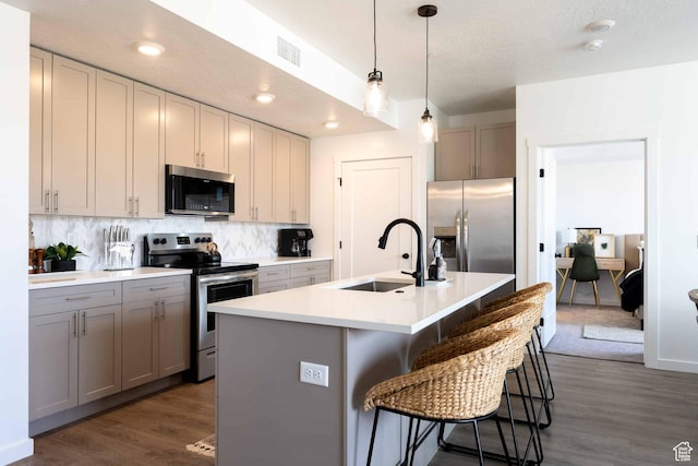 875 W Akoya Pearl St Unit 205, St George, UT 84790 - kitchen with appliances with stainless steel finishes, dark wood-style floors, decorative backsplash, light countertops, and recessed lighting