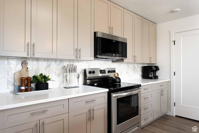 875 W Akoya Pearl St Unit 205, St George, UT 84790 - kitchen featuring appliances with stainless steel finishes, light countertops, backsplash, gray cabinets, and a textured ceiling