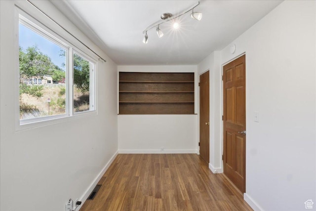 537 N Darwin St W, Salt Lake City, UT 84103 - spare room with wood finished floors and rail lighting