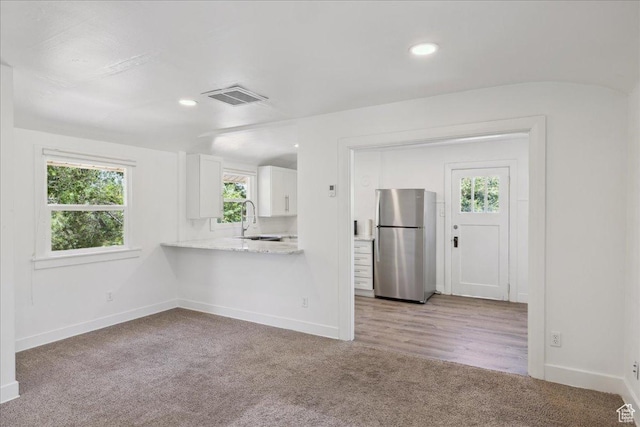 537 N Darwin St W, Salt Lake City, UT 84103 - kitchen with freestanding refrigerator, white cabinetry, light carpet, plenty of natural light, and recessed lighting