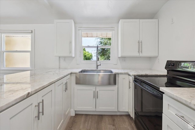 537 N Darwin St W, Salt Lake City, UT 84103 - kitchen with black electric range, white cabinetry, wood finished floors, and light stone counters