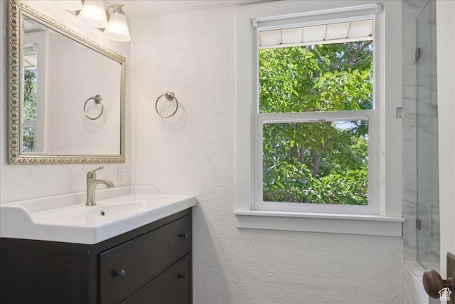 537 N Darwin St W, Salt Lake City, UT 84103 - full bathroom featuring vanity, a textured wall, and healthy amount of natural light