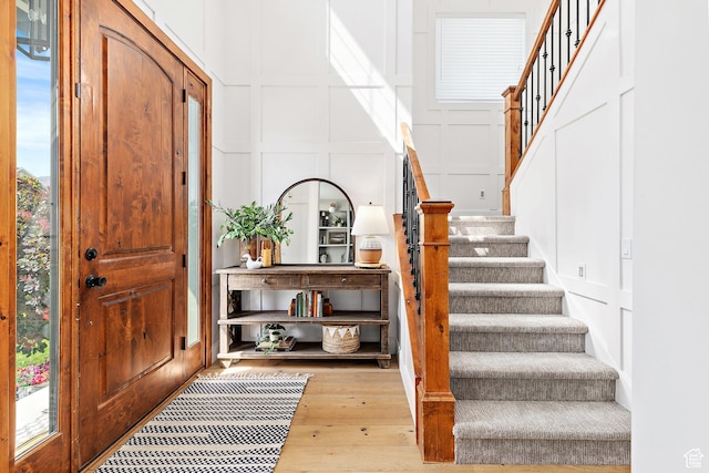 1471 S Sage Bloom Way, Saratoga Springs, UT 84045 - foyer featuring a decorative wall, stairway, and wood finished floors