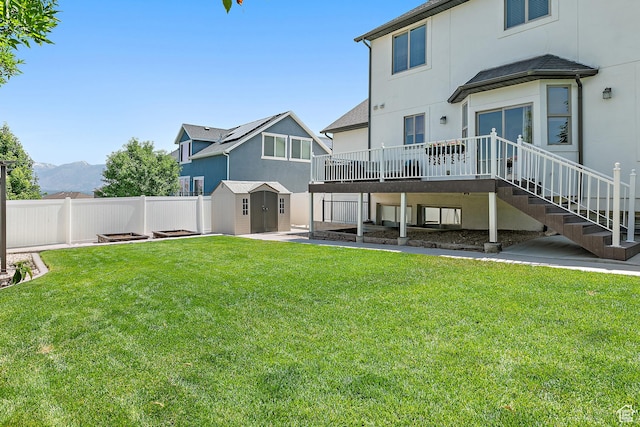 1471 S Sage Bloom Way, Saratoga Springs, UT 84045 - rear view of property featuring a storage unit, a wooden deck, a fenced backyard, stucco siding, and stairs
