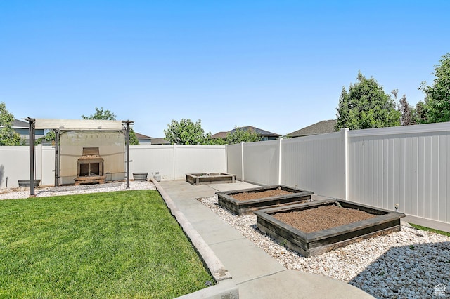 1471 S Sage Bloom Way, Saratoga Springs, UT 84045 - fenced backyard with exterior fireplace and a vegetable garden