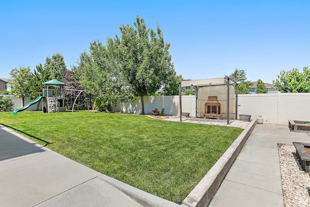 1471 S Sage Bloom Way, Saratoga Springs, UT 84045 - fenced backyard featuring a tile fireplace and a patio area
