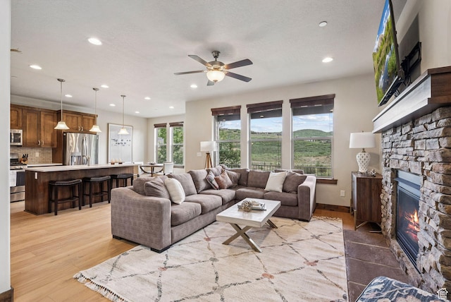 1046 W Abigail Dr, Heber City, UT 84032 - living area featuring recessed lighting, a fireplace, a ceiling fan, and light wood finished floors
