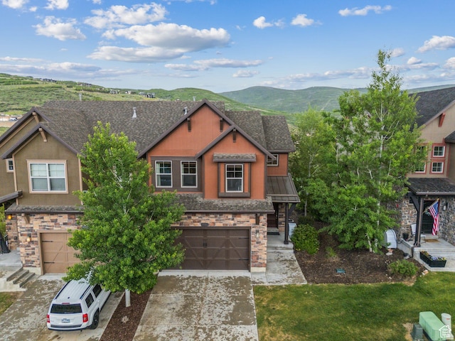 1046 W Abigail Dr, Heber City, UT 84032 - view of front of home with stone siding, an attached garage, a mountain view, and concrete driveway