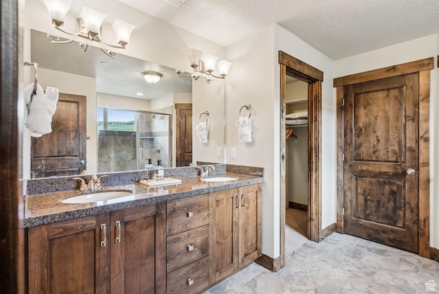 1046 W Abigail Dr, Heber City, UT 84032 - full bath featuring a shower stall, double vanity, a spacious closet, a textured ceiling, and a chandelier