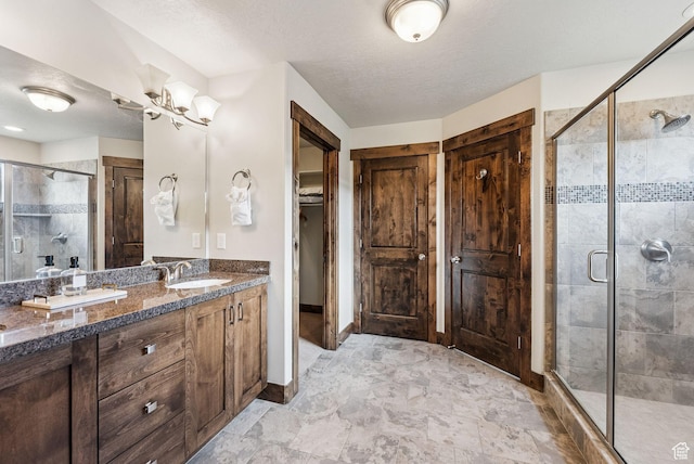1046 W Abigail Dr, Heber City, UT 84032 - full bath with a shower stall, double vanity, a chandelier, a textured ceiling, and a spacious closet
