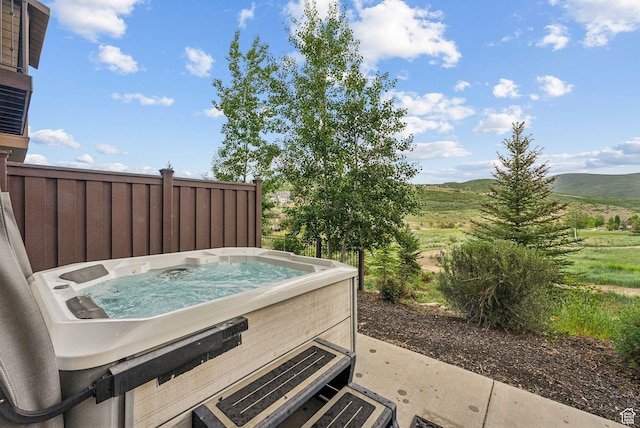 1046 W Abigail Dr, Heber City, UT 84032 - view of patio / terrace with a hot tub and a mountain view