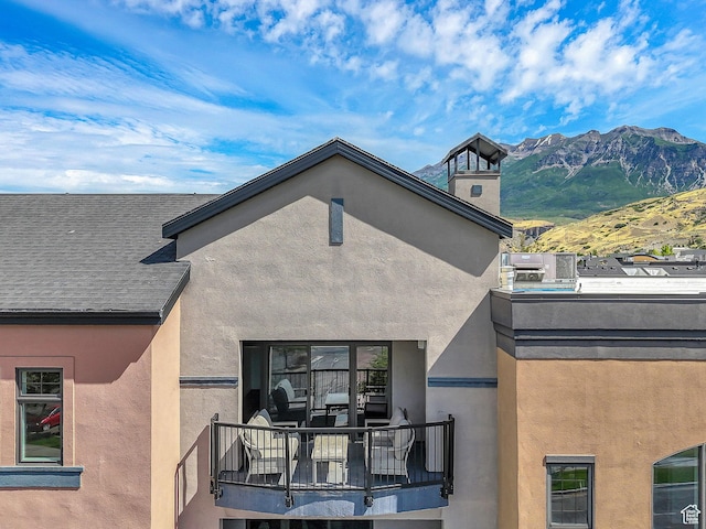 5005 N Edgewood Dr W Unit 301, Provo, UT 84604 - back of house with a balcony, a mountain view, stucco siding, and a chimney