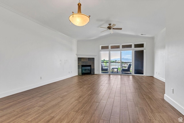 5005 N Edgewood Dr W Unit 301, Provo, UT 84604 - unfurnished living room featuring wood finished floors, a ceiling fan, vaulted ceiling, a tile fireplace, and ornamental molding