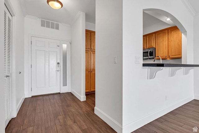 5005 N Edgewood Dr W Unit 301, Provo, UT 84604 - entrance foyer with dark wood finished floors, arched walkways, and ornamental molding