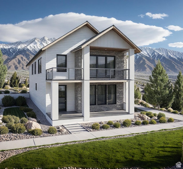 5367 W Tiva Ln Unit 6, Highland, UT 84003 - contemporary home featuring a balcony, stone siding, covered porch, and a mountain view
