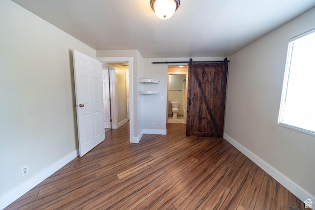 685 W 2550 S, Price, UT 84501 - unfurnished bedroom featuring wood finished floors, a barn door, and multiple windows