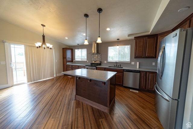 685 W 2550 S, Price, UT 84501 - kitchen featuring appliances with stainless steel finishes, a chandelier, a kitchen island, dark wood-style flooring, and pendant lighting