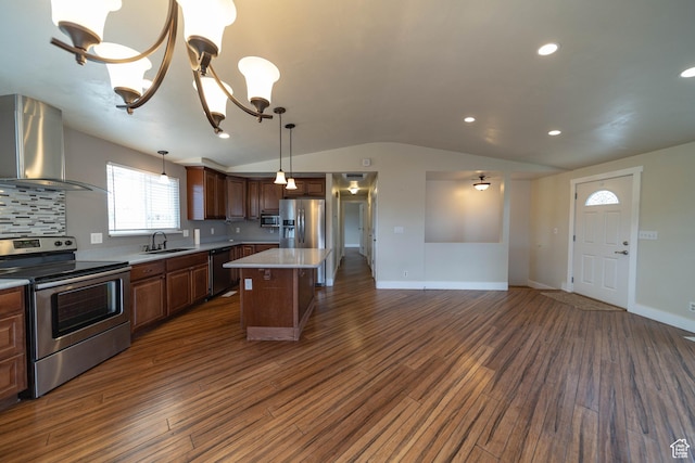 685 W 2550 S, Price, UT 84501 - kitchen featuring appliances with stainless steel finishes, ventilation hood, vaulted ceiling, dark wood finished floors, and decorative backsplash