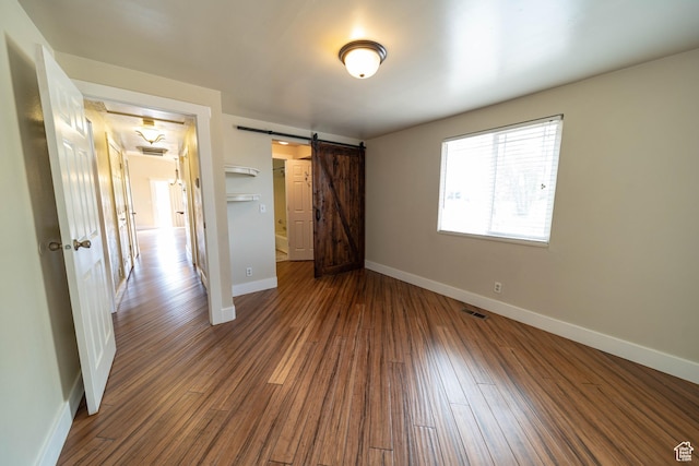 685 W 2550 S, Price, UT 84501 - unfurnished bedroom featuring wood finished floors and a barn door