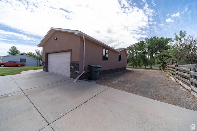 685 W 2550 S, Price, UT 84501 - view of home's exterior with concrete driveway, stucco siding, and stone siding