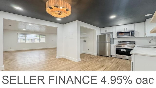 1464 S 50 E, Orem, UT 84058 - kitchen with appliances with stainless steel finishes, light wood-style flooring, white cabinetry, recessed lighting, and open floor plan