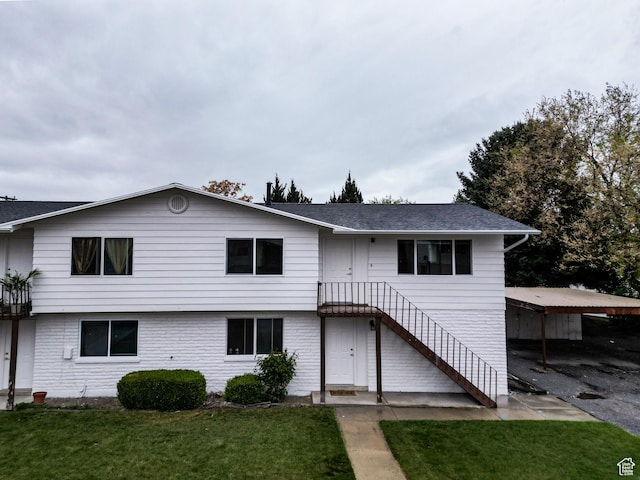 1464 S 50 E, Orem, UT 84058 - view of front of house with a detached carport, a front lawn, a shingled roof, and stairs