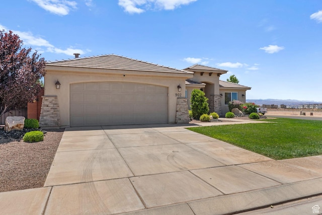 902 E 3950 S, Washington, UT 84780 - view of front of property featuring stone siding, stucco siding, an attached garage, and driveway