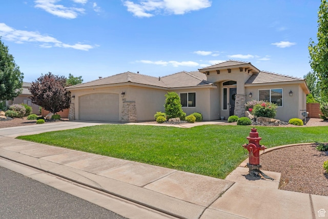902 E 3950 S, Washington, UT 84780 - mediterranean / spanish-style home featuring stucco siding, a garage, a front lawn, a tiled roof, and driveway