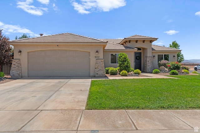 902 E 3950 S, Washington, UT 84780 - view of front facade with stucco siding, a front lawn, stone siding, and an attached garage