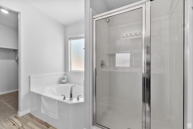 902 E 3950 S, Washington, UT 84780 - bathroom with a shower stall, a garden tub, wood finished floors, and a spacious closet