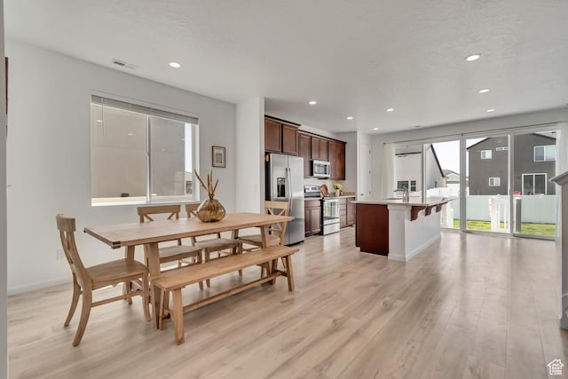 5451 N Yeager Ln, Eagle Mountain, UT 84005 - dining space featuring light wood finished floors and recessed lighting