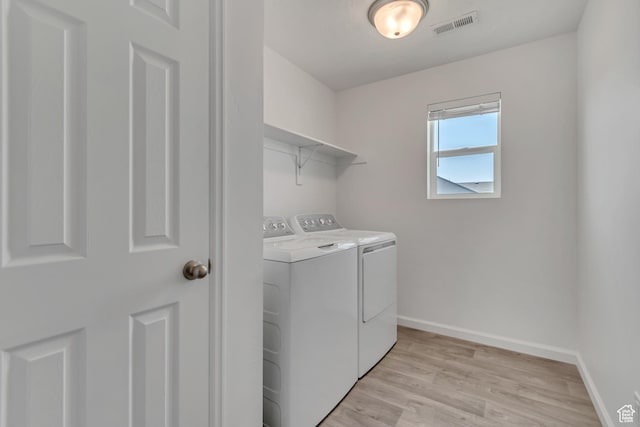 5451 N Yeager Ln, Eagle Mountain, UT 84005 - laundry area with washing machine and dryer and light wood-style floors