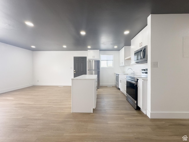 34 E 1450 S, Orem, UT 84058 - kitchen featuring stainless steel appliances, a center island, light wood-style floors, white cabinetry, and recessed lighting