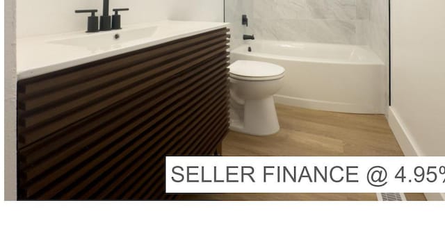 34 E 1450 S, Orem, UT 84058 - full bath featuring wood finished floors, vanity, and bathtub / shower combination