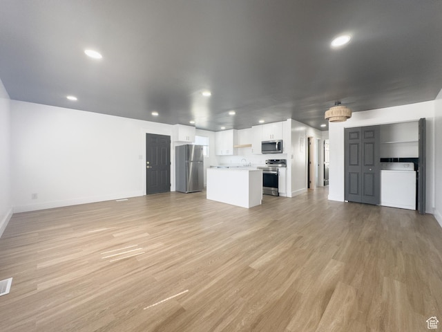 34 E 1450 S, Orem, UT 84058 - unfurnished living room with washer / dryer, light wood-style flooring, and recessed lighting