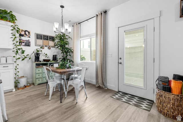 2122 W 1745th Ct S, West Haven, UT 84401 - dining room with light wood-style flooring and a chandelier