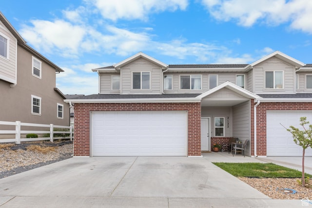 2122 W 1745th Ct S, West Haven, UT 84401 - view of front of property featuring brick siding, a garage, and driveway