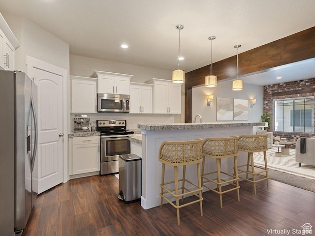 5529 W Sicily Ln N, Highland, UT 84003 - kitchen with stainless steel appliances, dark wood-type flooring, a kitchen breakfast bar, white cabinets, and recessed lighting
