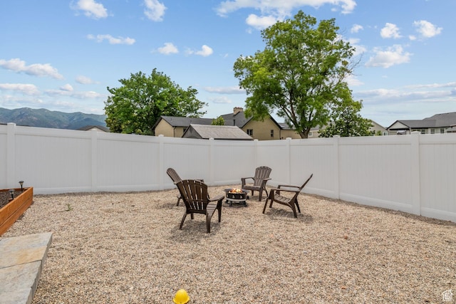 2245 W 800 S, Layton, UT 84041 - fenced backyard featuring an outdoor fire pit and a mountain view