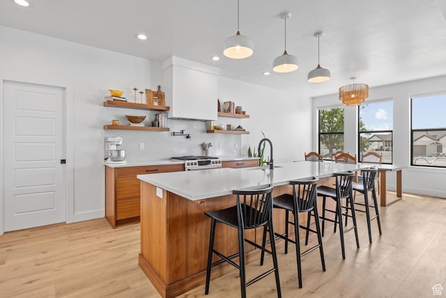 2245 W 800 S, Layton, UT 84041 - kitchen with open shelves, range with gas stovetop, light wood-style flooring, light countertops, and decorative backsplash
