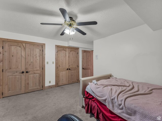 11551 S Woodhampton Dr E, Sandy, UT 84092 - carpeted bedroom featuring a textured ceiling and ceiling fan