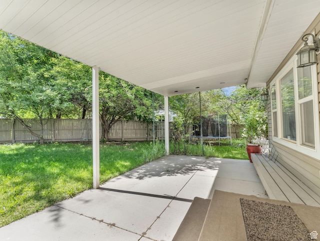 11551 S Woodhampton Dr E, Sandy, UT 84092 - fenced backyard featuring a trampoline and a patio area