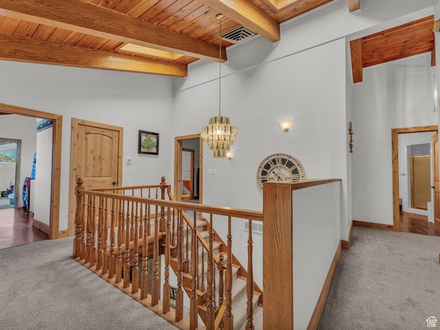 11551 S Woodhampton Dr E, Sandy, UT 84092 - corridor with an upstairs landing, carpet floors, a chandelier, and a wooden ceiling with exposed beams