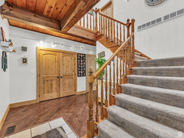 11551 S Woodhampton Dr E, Sandy, UT 84092 - entryway featuring tile patterned floors, stairway, and a wood ceiling with exposed beams