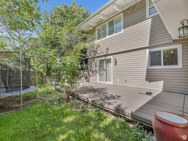 11551 S Woodhampton Dr E, Sandy, UT 84092 - back of house with a trampoline and a wooden deck