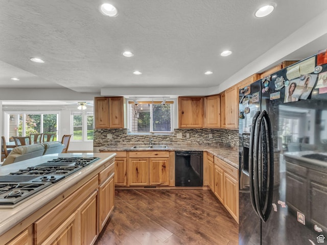 11551 S Woodhampton Dr E, Sandy, UT 84092 - kitchen with black appliances, recessed lighting, healthy amount of natural light, dark wood-type flooring, and backsplash